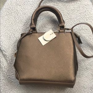 Dark pink metallic hand bag with cross body strap